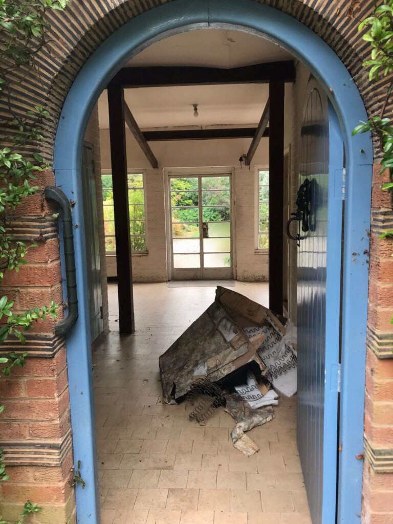 Berkeley House Clearance in Solihull Birmingham. House clearance service in progress at home in Dorridge area of Solihull. View through front doorway showing last bits of waste and rubbish piled up ready and for removal