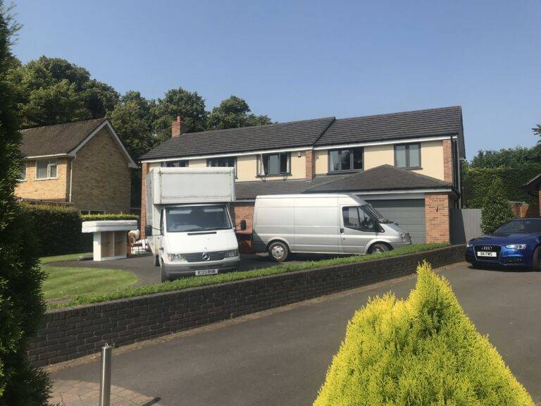 Terrys vans parked outside a home in Sutton Coldfield. Furniture has been removed from the property and is ready to be loaded onto the van.