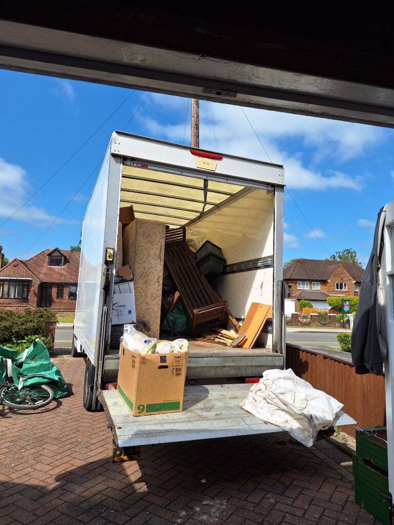 Berkeley House Clearance in Streetly, Sutton Coldfield. Terry's van parked on driveway of house in Blackwood Drive. Furniture and household effects loaded on van. Items cleared from home and ready for recycling.