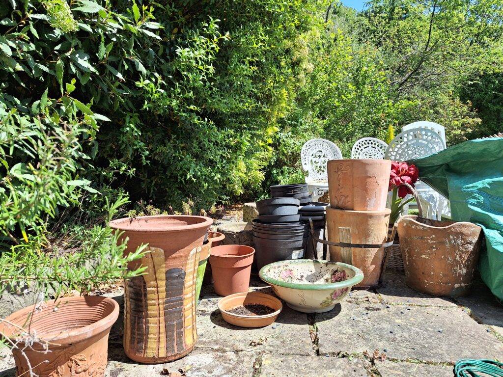 Berkeley House Clearance. Our Services in Streetly. Pots and general waste lined up and ready for removal and recycling in garden at home in Blackwood Drive, Streetly area of Sutton Coldfield. Property clearance services in Sutton Coldfield Birmingham and Solihull