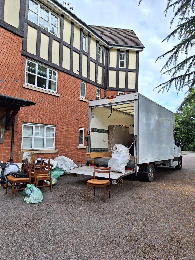 Terrys van parked at a flat in Wylde Green. furniture and other household Items outside waiting to load onto van. Berkeley HOuse Clearance in Sutton Coldfield.