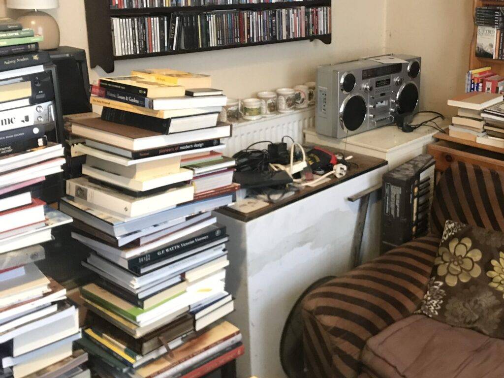 Books and other household items in room that we have been instructed to clear. Berkeley House clearance services Minworth in Sutton Coldfield.