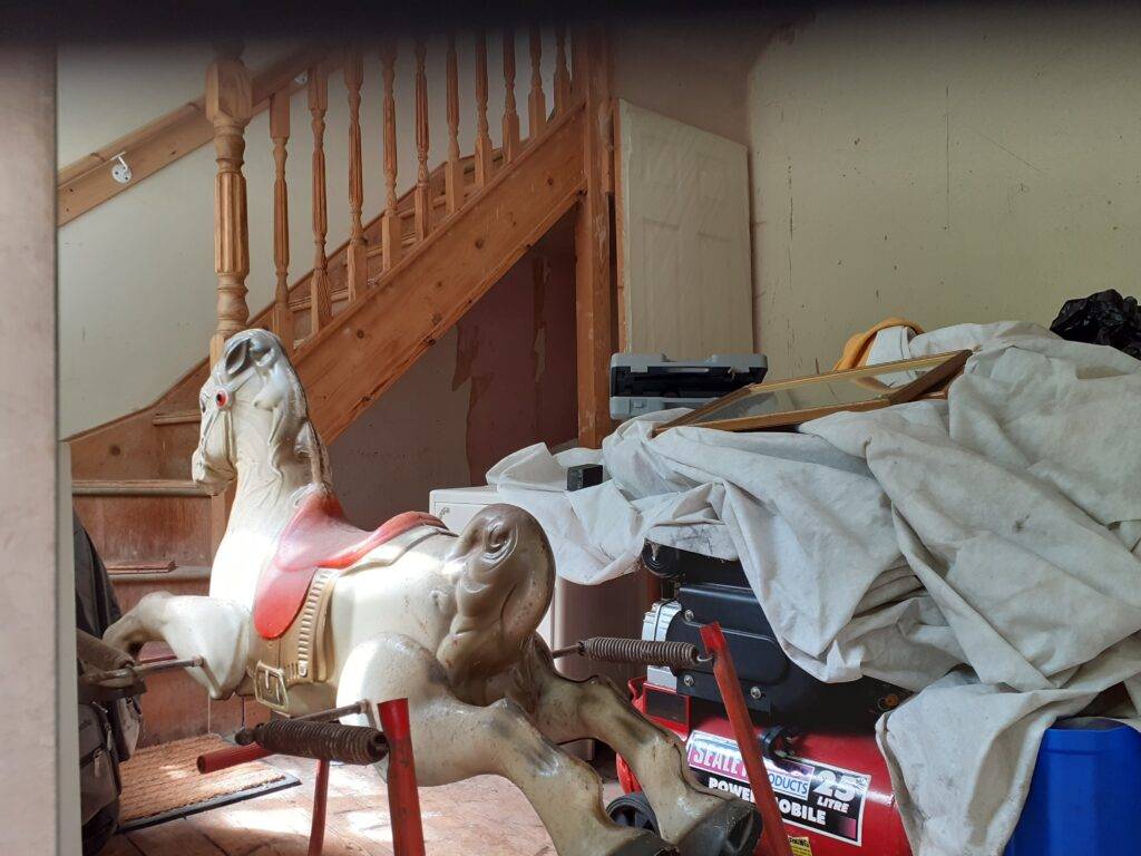 House clearance Sutton Coldfield. Berkeley House Clearance at a home in Streetly. Decluttering support and recycling services. Items in hallway that are have been sorted and bagged. Some ready for removal Rocking horse is marked to stay. 