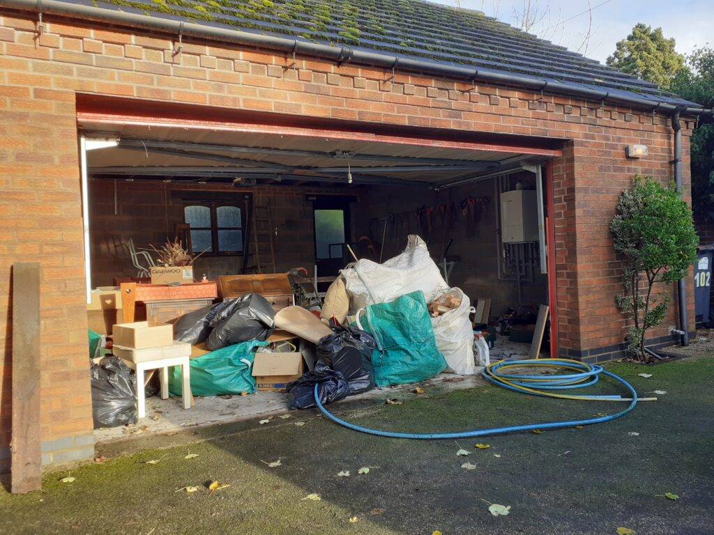 Garage clearance services in Birmingham. Showing items in garage that have been removed from main property. Items are ready for removal and recycling.
